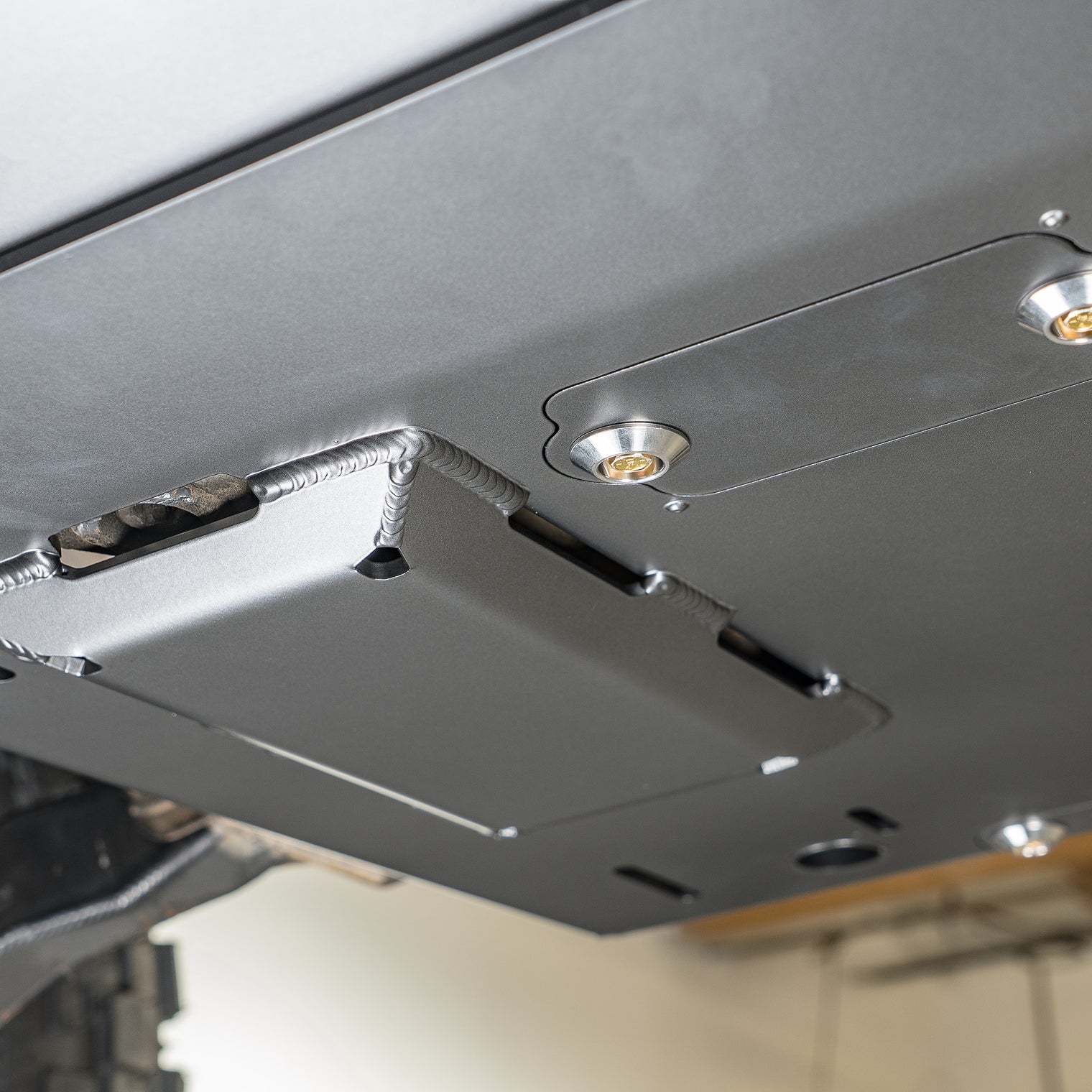Product photo of the DRT crossmember delete skid plate kit before install, raw steel finish