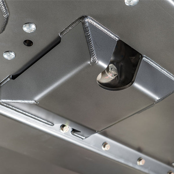 DRT flat belly skid plate kit ground clearance demonstrated next to OEM crossmember for comparison