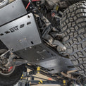 DRT crossmember delete skid plate and replacement crossmember installed under a Tacoma showing roughly 5 inches of clearance gain