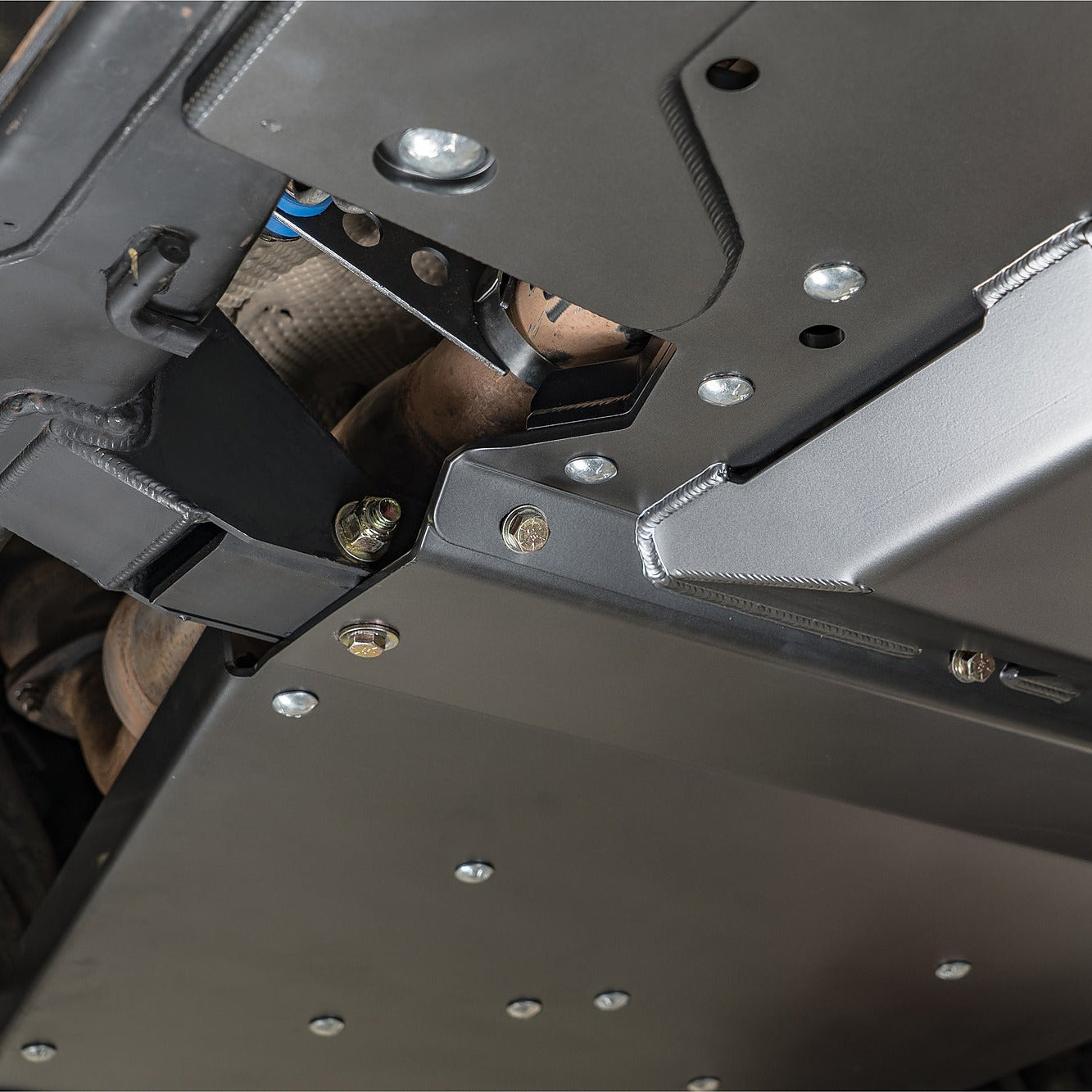 Side view of the DRT high-clearance transmission crossmember installed on a Tacoma 4x4
