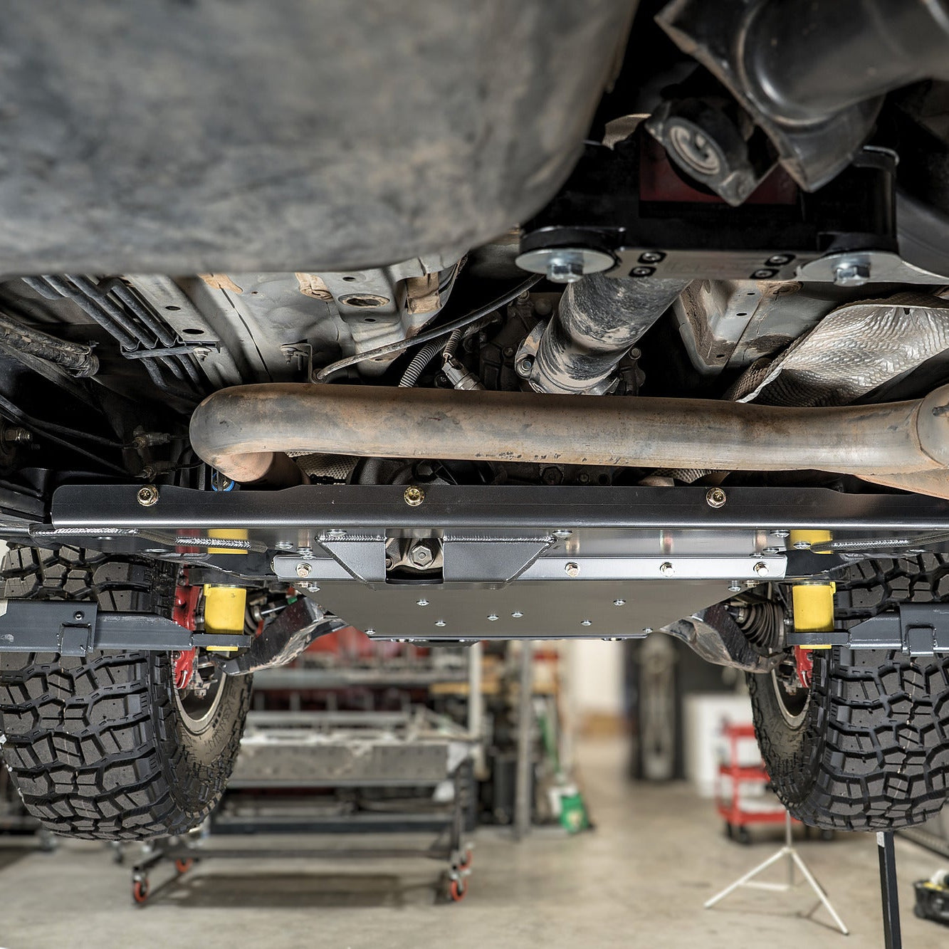 Bottom view showing the flat belly skid plate fully installed on a 2005-2023 Toyota Tacoma