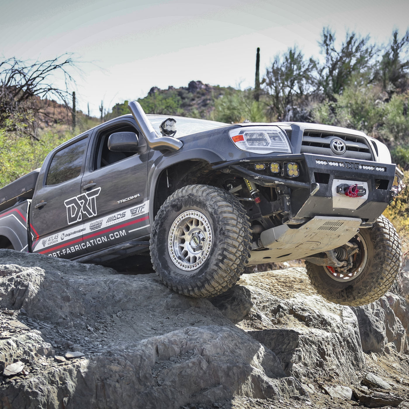 Toyota truck on a rocky trail with desert landscape