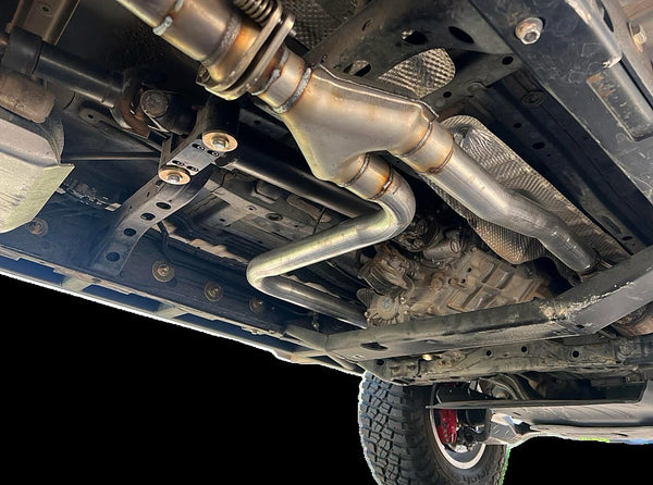 Rerouted exhaust on a 2005-2023 Toyota Tacoma clearing the DRT flat belly transfer case skid crossmember